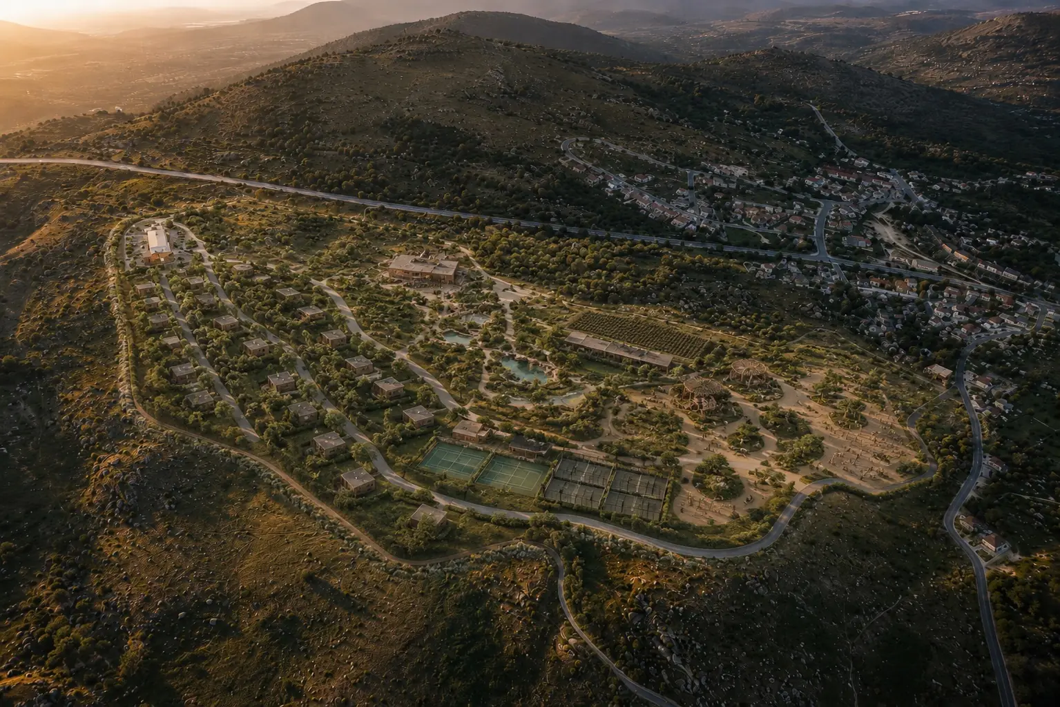 The estate seen from high above at sunset, the surrounding dehesa and the village of El Boalo beyond