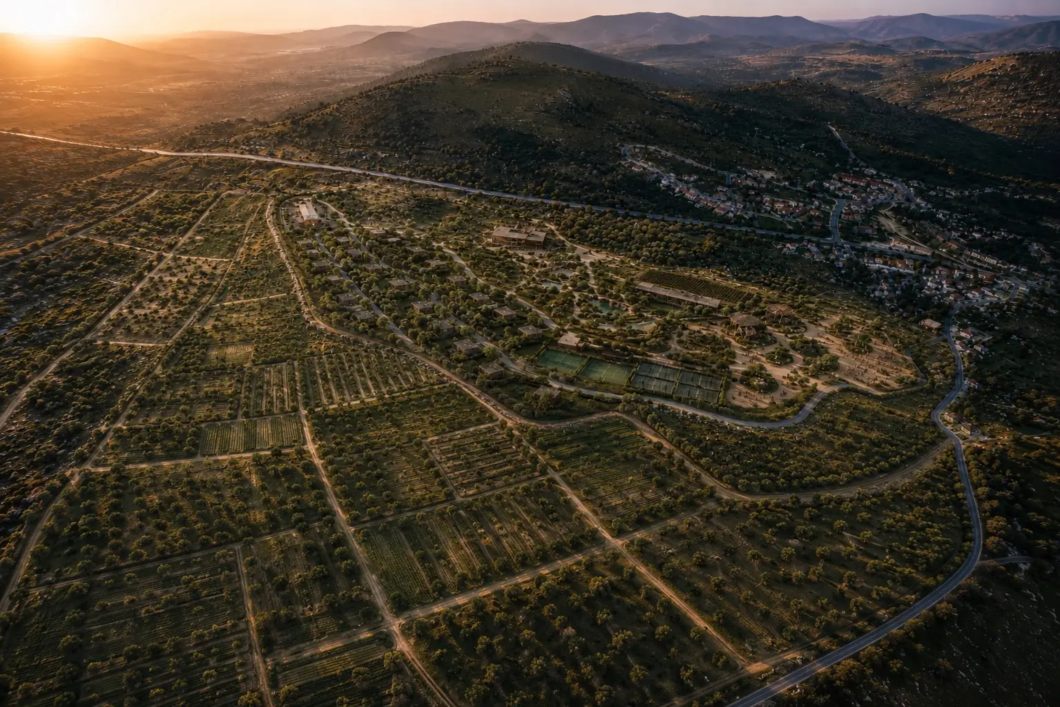 The same view with the surrounding land under cultivation: orchards, vines and field crops wrapping the estate